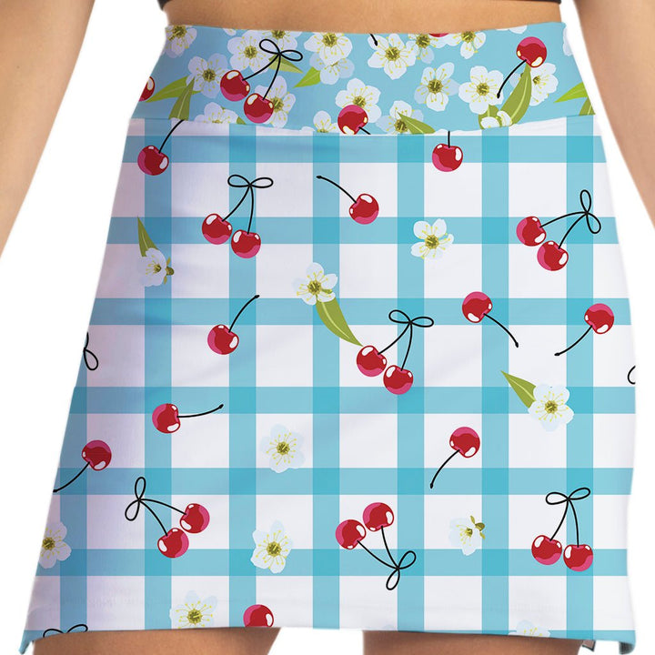 Skirt with blue checkered pattern, red cherries, and white flowers on a white background