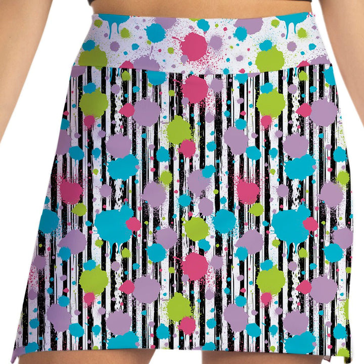 Colorful patterned skirt with polka dots and stripes on a white background